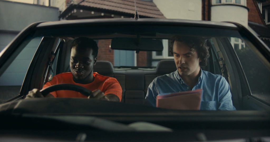 Josh Tedeku as Jamal behind the wheel of his first car in Remi R.M. Moses’ British short film Hindsight.
