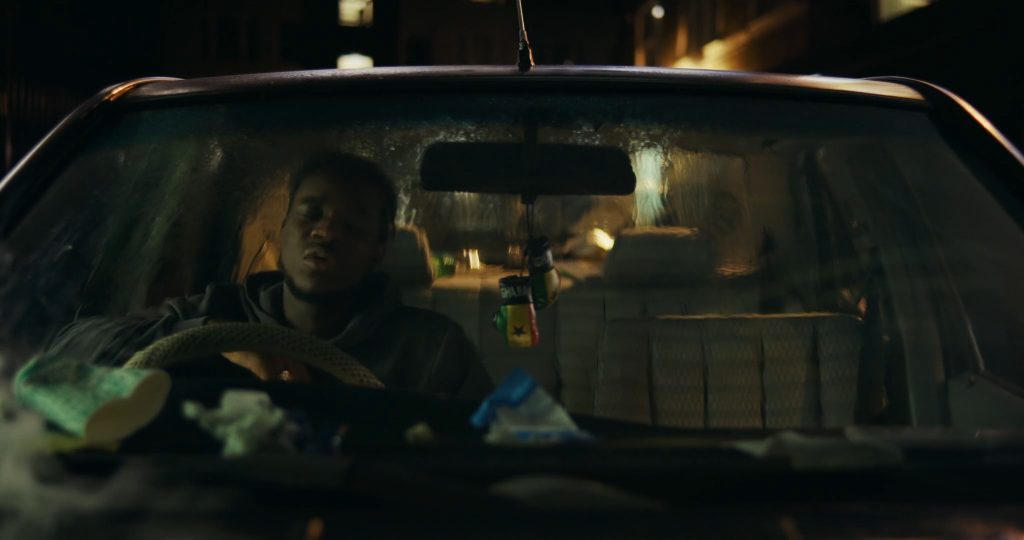 Josh Tedeku as Jamal behind the wheel of his first car in Remi R.M. Moses’ British short film Hindsight.