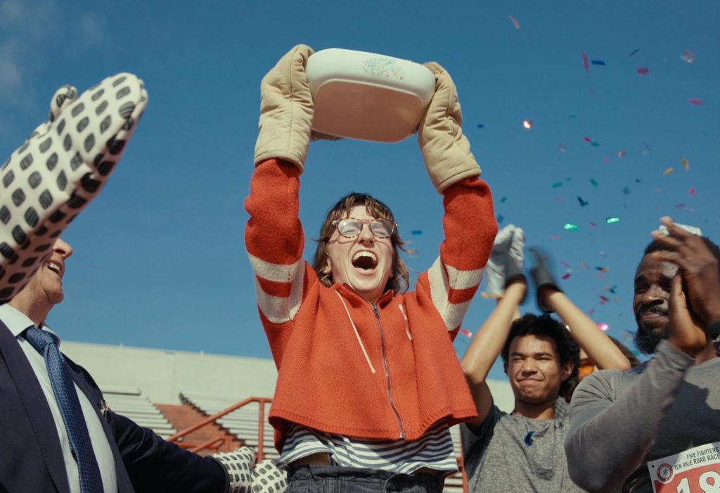 Danielle Pollari as Connie carrying a lasagna on her surreal journey in James Livitski's short film Lasagna Run