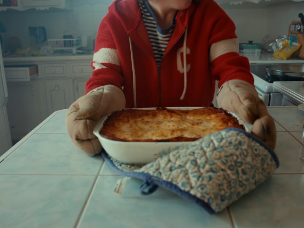 Danielle Pollari as Connie carrying a lasagna on her surreal journey in James Livitski's short film Lasagna Run